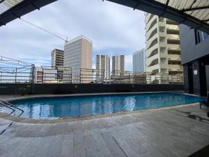 a swimming pool on the roof of a building with buildings at Nagoya Mansion Residence with City View in Nagoya