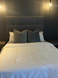 a large white bed with pillows in a bedroom at Apartment with Mountain views Wex1 in Cape Town +29 photos