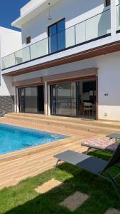 a house with a swimming pool in front of it at la Villa WOOR Saly Joseph in Mbour
