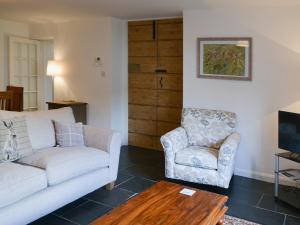 a living room with a couch and a chair at Tower House in Ambleside