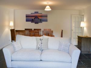 a white couch with pillows on it in a living room at Tower House in Ambleside