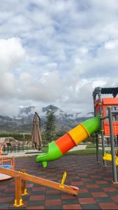 a playground with a slide in a park at Porta e Alpeve in Gradec