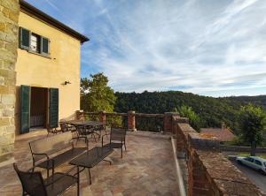 a patio with a table and chairs on a balcony at TUSCANFLAT Castle in Scrofiano