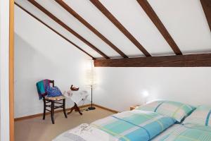 a bedroom with a bed and a table and a chair at Haus Palais in Münstertal
