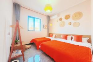 En eller flere senge i et værelse på Nanshan Ski Resort - Nanshan Muxue Homestay