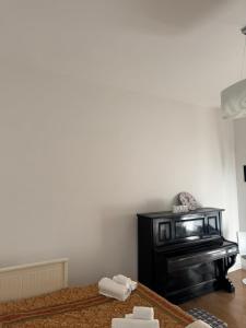 a living room with a bed and a piano at IELLE Suite Brutia in Cosenza +6 photos