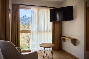 a room with a window with a table and a chair at Die Monika Aparthotel in Gaschurn