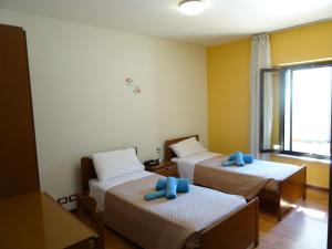 Postel nebo postele na pokoji v ubytování Hotel Galles