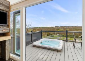 a jacuzzi tub on the deck of a house at Celtic Escapes in Narberth