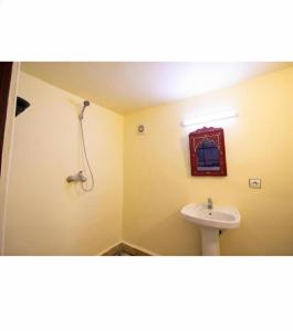 a bathroom with a sink and a shower at Riad BAB JDID in Fès
