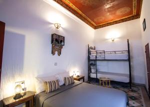a bedroom with a bed and a ceiling at Riad BAB JDID in Fès
