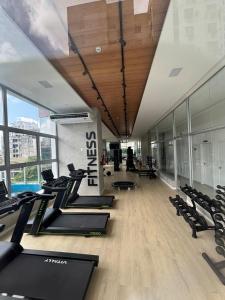 a gym with treadmills and elliptical machines at AP Premium Lazer Completo Academia Rooftop Coworking e Estacionamento in Belém