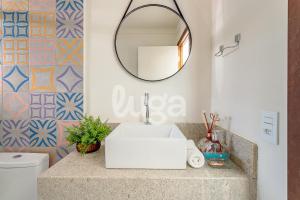 a bathroom with a sink and a mirror at Vieira Eco Inn – Deluxe Suite Thiago #3 in Orleans +19 photos