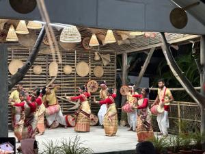 a group of people dancing on a stage at Lokosha Resort - The Green Destination in Hatikhuli
