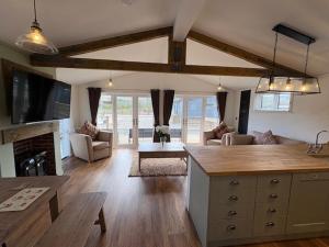 a kitchen and living room with a couch and a table at LOCH NESS HIGHLAND Resort in Fort Augustus