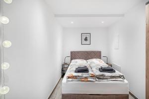 a bed in a room with white walls at Tor zum Hochwald in Thomm
