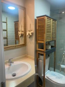 a bathroom with a sink and a mirror and a toilet at Rony by Best Holidays Fuerteventura in Corralejo