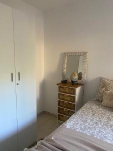 a bedroom with a bed and a dresser with a mirror at Rony by Best Holidays Fuerteventura in Corralejo +10 photos
