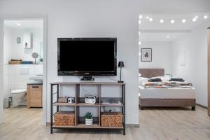 a living room with a flat screen tv on a shelf at Tor zum Hochwald in Thomm