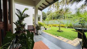a porch with a view of a garden at Green Villa Matale in Palapatwela