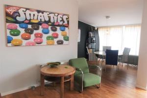 a living room with a table and some chairs at Hello Zeeland - Margrietenlaan 5 in Oostkapelle