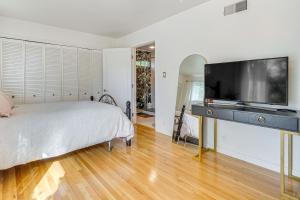 a bedroom with a bed and a flat screen tv at Work and Relax! Updated Walnut Creek Home with Office in Walnut Creek