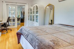 a bedroom with a bed and a desk and a mirror at Work and Relax! Updated Walnut Creek Home with Office in Walnut Creek