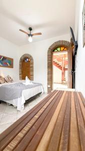 a bedroom with a bed and a ceiling fan at Pousada Maken Hary - Centro in Arraial d'Ajuda +87 photos