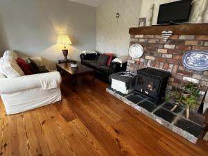 a living room with a couch and a fireplace at Hillview House, Donegal Town in Donegal