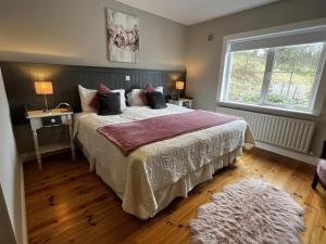 a bedroom with a large bed and a window at Hillview House, Donegal Town in Donegal
