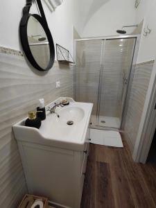 a white bathroom with a sink and a shower at La Ginestra in Bastia +9 photos