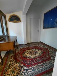 a room with a rug on the floor next to a piano at La Ginestra in Bastia +2 photos