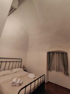 a bedroom with a bed with two towels on it at La Ginestra in Bastia
