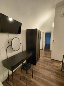 a room with a desk and a tv on the wall at La Ginestra in Bastia