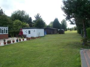 un gran patio con una casa y un edificio en London Heathrow Guesthouse en Hillingdon