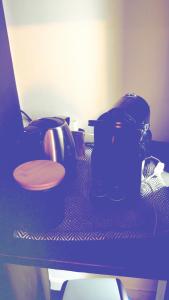 a table with a blue light on top at tour des étoiles love room in Trévoux