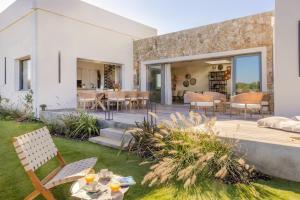 a garden with a wooden deck with chairs and tables at Villa Yaya in Cervione