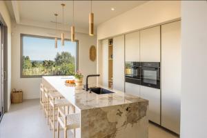 a kitchen with a large island with a counter top at Villa Yaya in Cervione