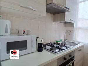 a kitchen with a microwave and a stove top oven at Vimodrone, modern accommodation near San Raffaele in Vimodrone +10 photos