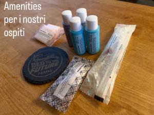 ein Holztisch mit drei Flaschen Flüssigkeit darauf in der Unterkunft Bed to the Future Parma in Parma + 2 Fotos