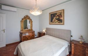 ein Schlafzimmer mit einem Bett, einem Spiegel und einer Kommode in der Unterkunft Villa Sophia by Nicola Real Estate in Corsanico-Bargecchia + 21 Fotos