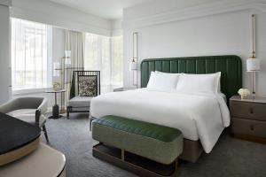 a bedroom with a large white bed and a chair at The Ritz-Carlton, Charlotte in Charlotte +69 photos