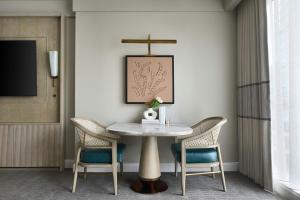 a dining room with a table and two chairs at The Ritz-Carlton, Charlotte in Charlotte