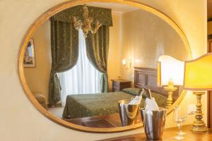 a hotel room with a mirror and a bed at Hotel Rigel in Venice-Lido