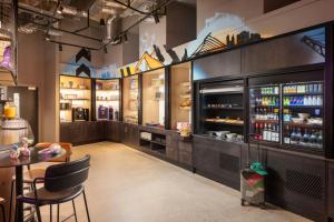 un restaurante con un bar con mesa y sillas en Moxy Dublin Docklands, en Dublín 23 fotos más