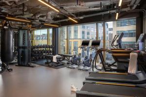 a gym with several treadmills and cardio machines at Moxy Dublin Docklands in Dublin