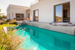 an image of a swimming pool in front of a house at Villa Yaya in Cervione