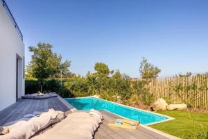 a backyard with a swimming pool and a deck with a pool at Villa Yaya in Cervione +41 photos