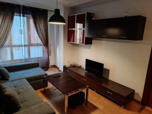 a living room with a couch and a table at Apartamento Guarnizo in Guarnizo