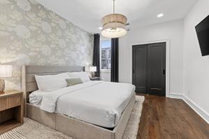 a bedroom with a bed and a wall with flowers at Luxury Condo - The Gulch - Private Rooftop in Nashville